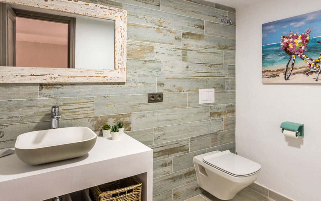 Contemporary rustic bathroom with weathered wall and raised basin in Mijas, Costa del Sol