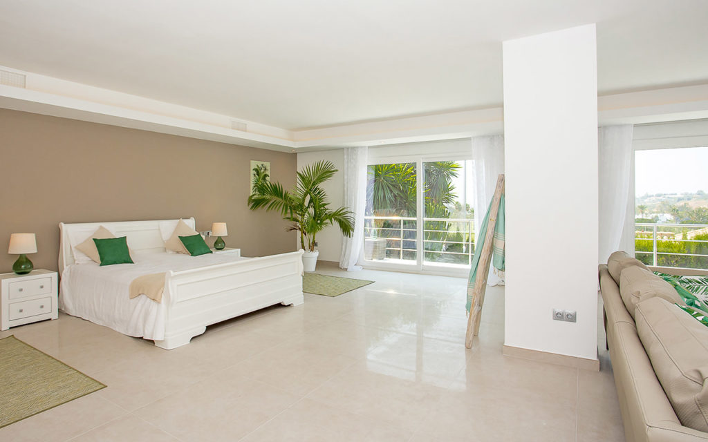 Large bedroom with lounge suite and balcony in Marbella