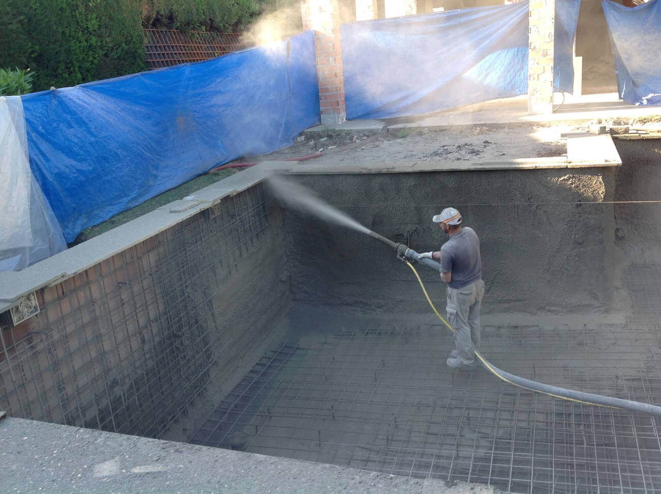 Applying concrete to the pool walls