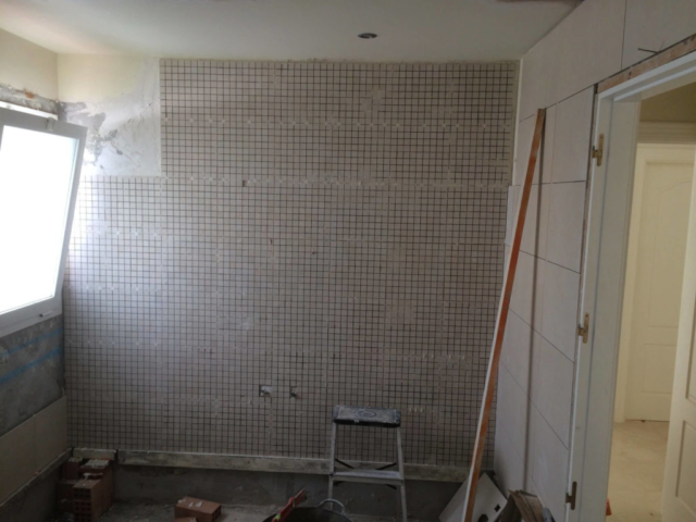 Tiles being applied to the walls