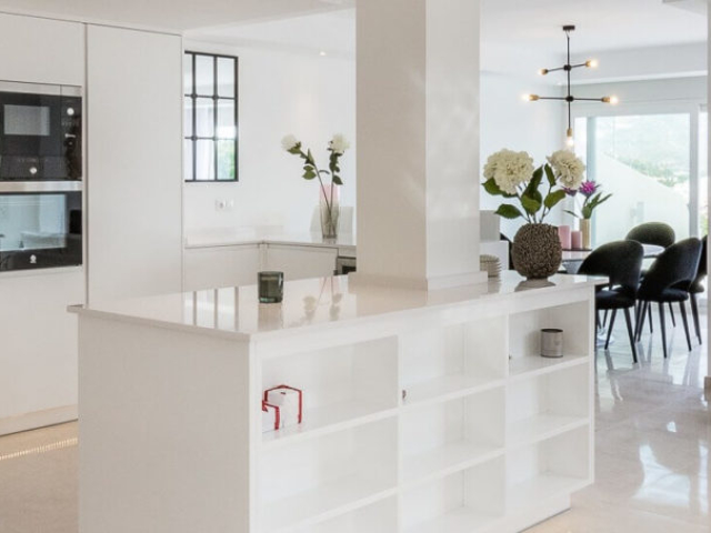 Stylish white open plan living and dinning area designed and built by ProMas in Marbella