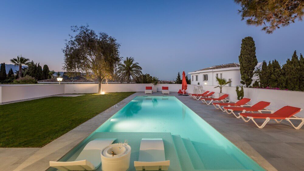 Stylish pool with in pool chair and sun loungers designed and built by ProMas In Mijas