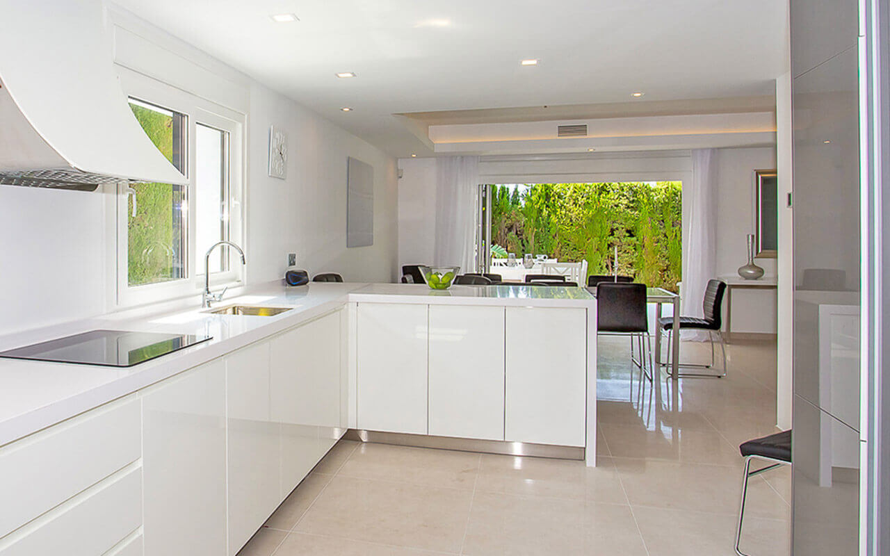 Modern white kitchen looking to terrace
