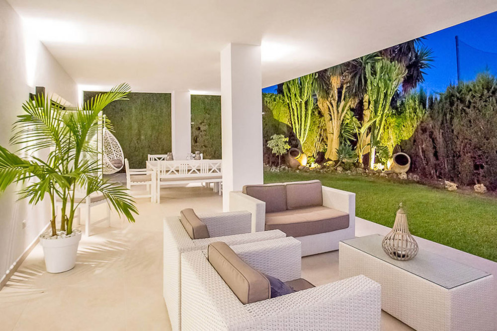 Stylish outdoor living area with Spanish garden and white furniture on the Costa del Sol