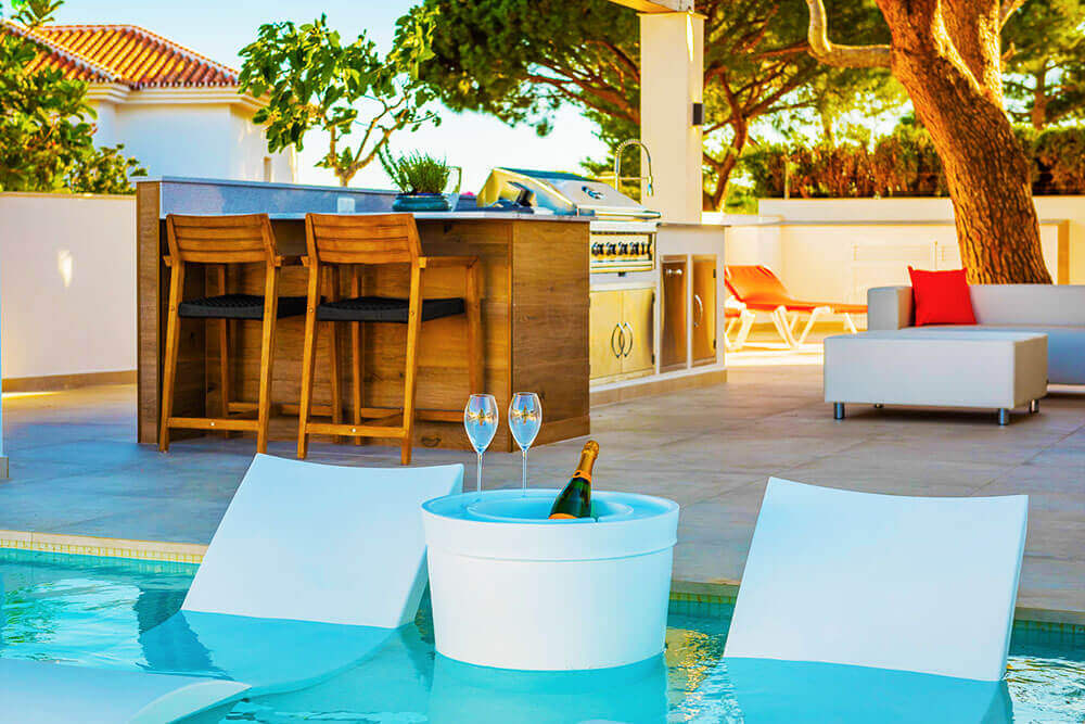 Stylish in pool relax chairs with outdoor kitchen and living in Mijas