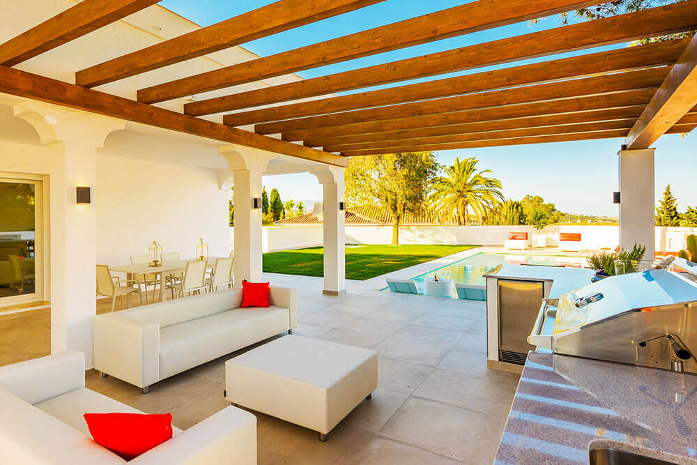 Stylish outdoor kitchen and living with pool relax zone designed and built by ProMas