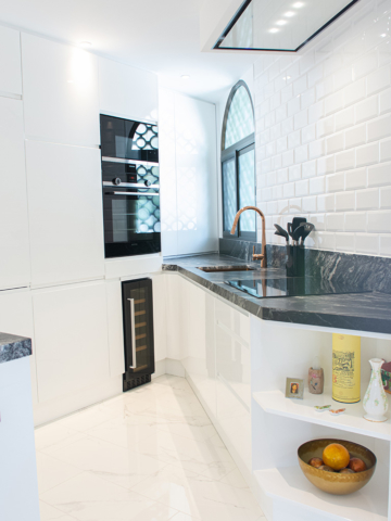 Stylish white and black corner kitchen design with wine fridge and open shelves