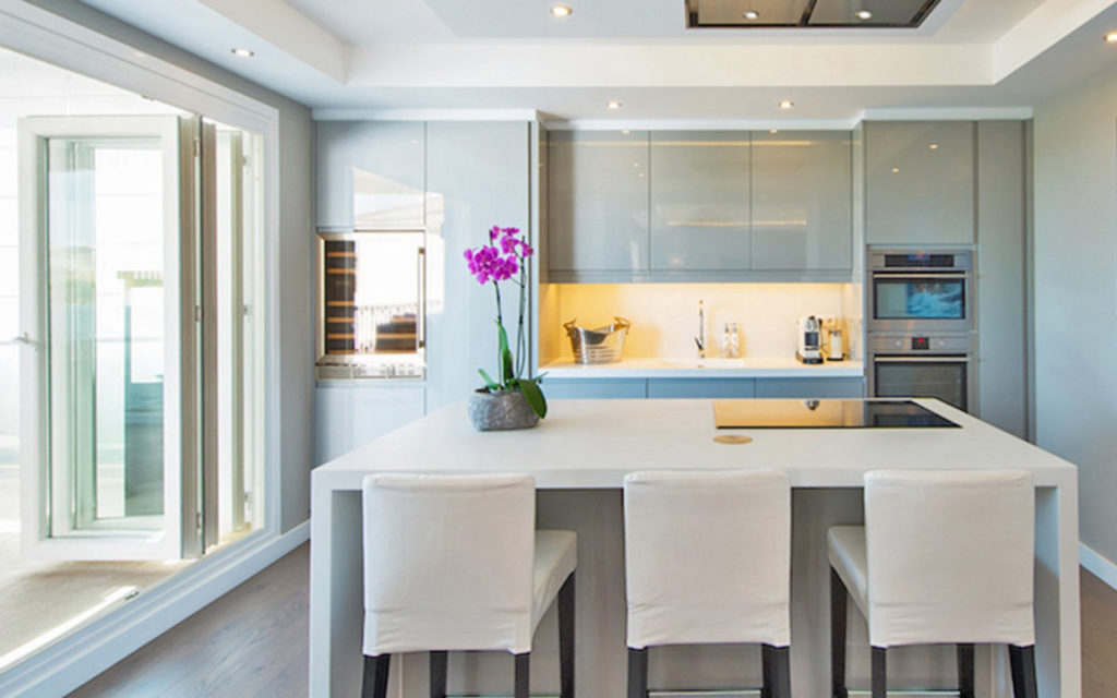 Stylish kitchen island with breakfast bar and grey tones