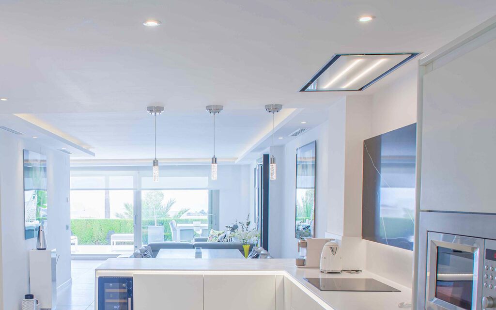 Combination of direct and indirect lighting in living room and kitchen