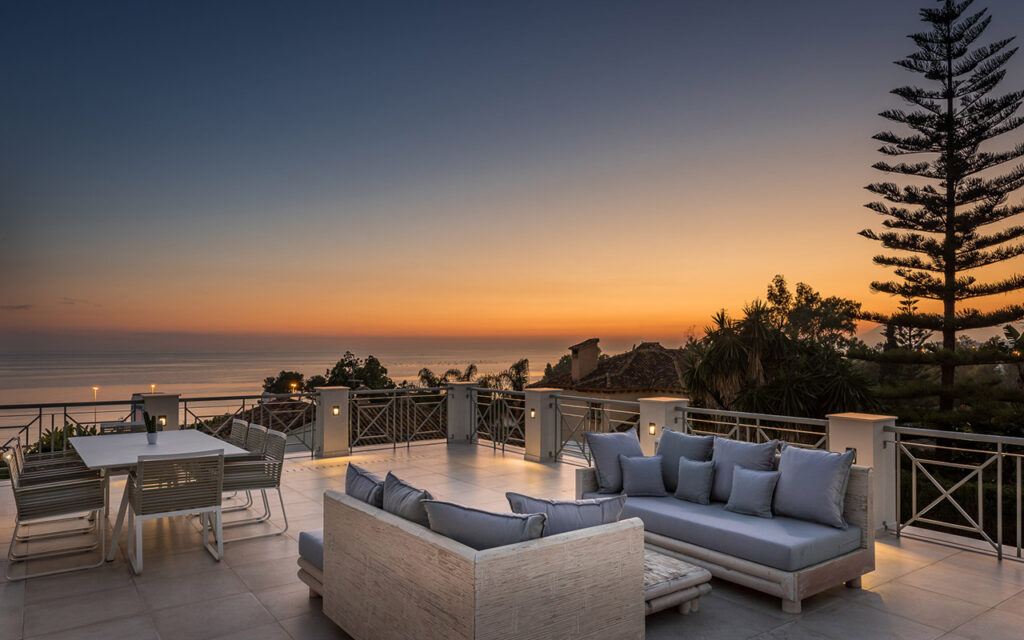 Relaxing rooftop at sunset of villa for sale in Marbella by Promas Estates. Costa del Sol. Builders in Marbella.