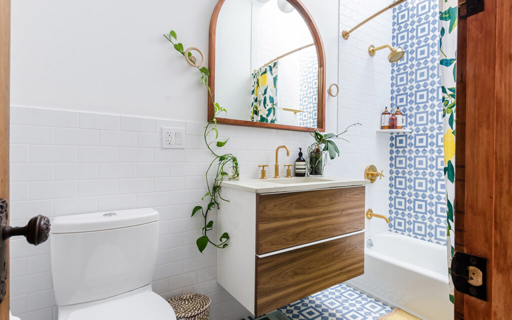 Funky bathroom with white, timber and geometric blue tiled feature walls