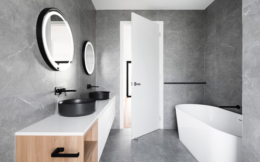 Modern grey bathroom with white and timber furniture and black accents