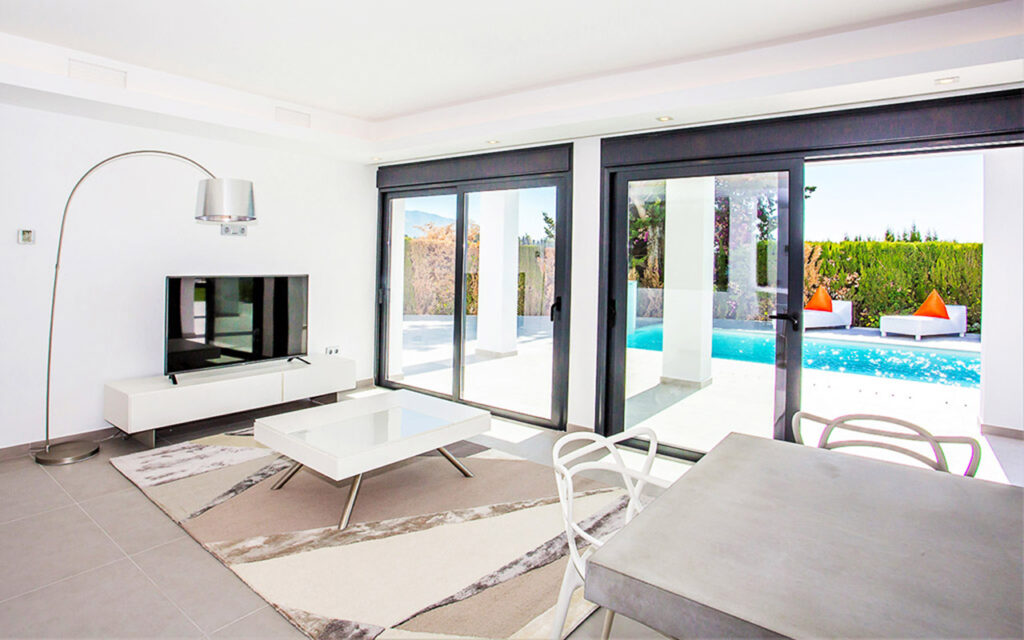 Black sliding doors to pool in Puerto Banus