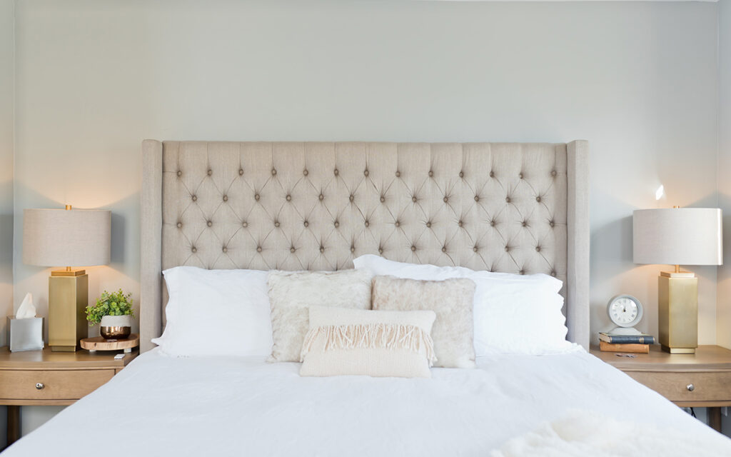 Beige bedroom suite with high cushioned headboard