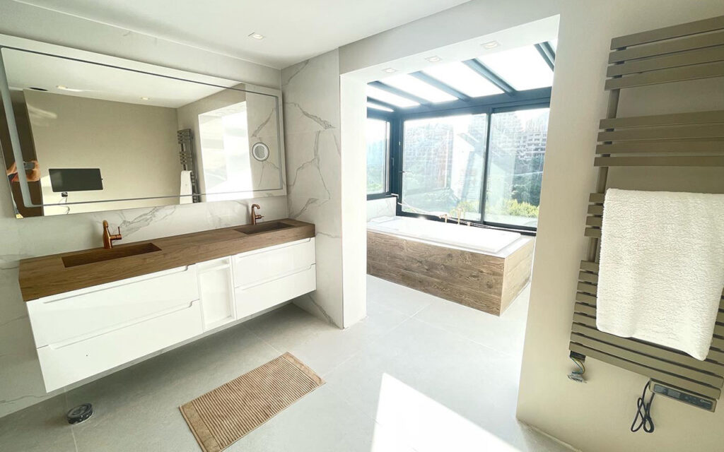 Incredible bathroom with standalone bath and double vanity by Promas Building