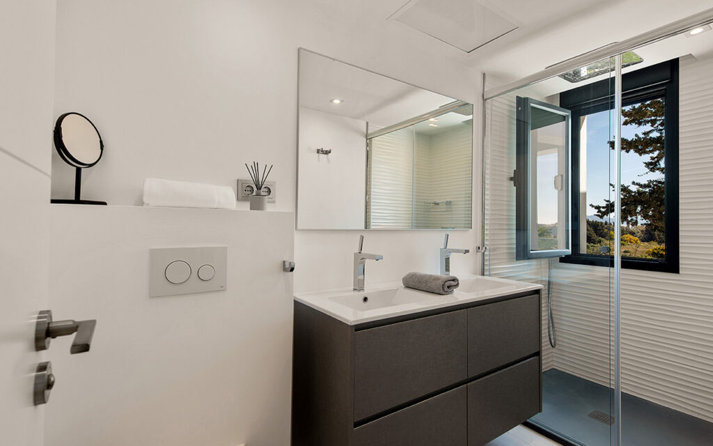 Black casement window in first floor bathroom with views