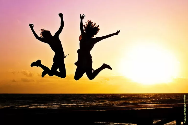 sunset beach jumping pexel