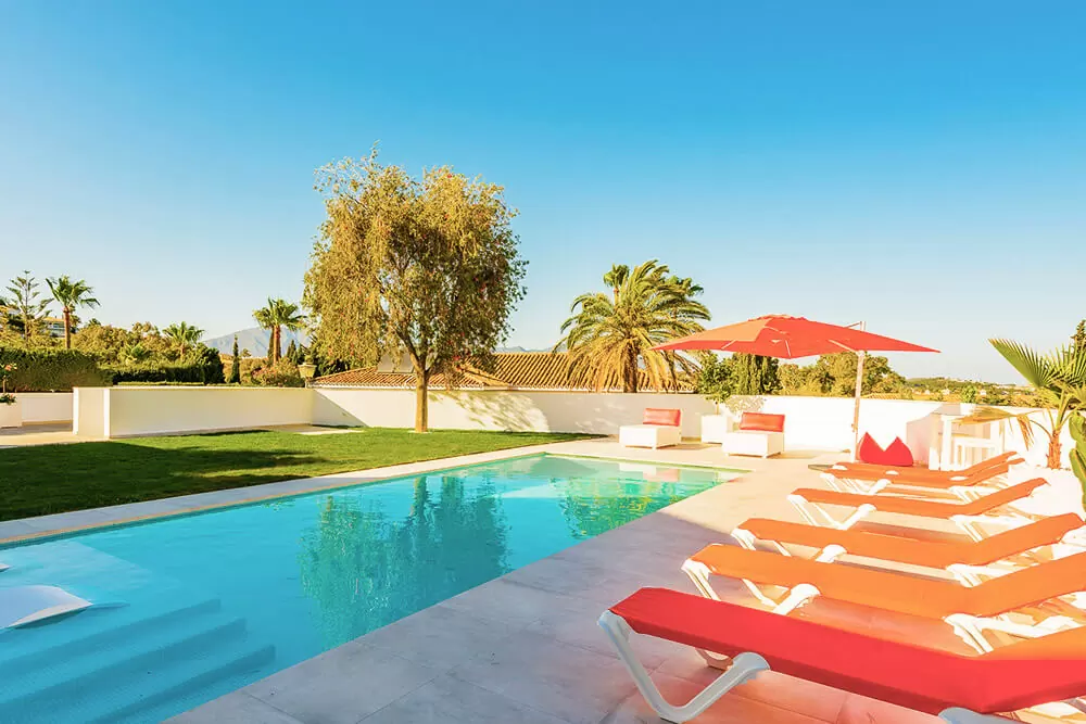 orange sunlounges by pool in costa del sol