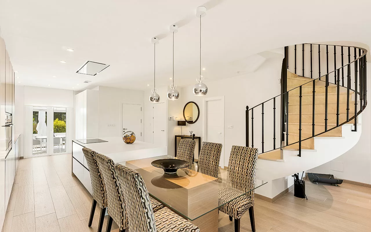 Modern open plan kitchen, dinning table and drop lights