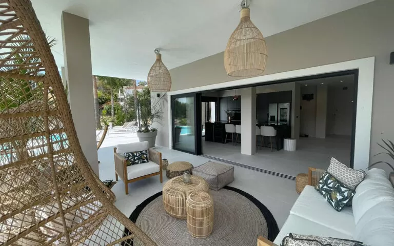 Black sliding doors opening indoor and outdoor living areas